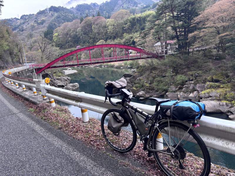 10:42,車停在護欄邊,後面就是那座紅橋,河裡都是大石頭。